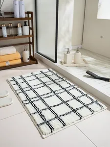 Detail of minimalist black and white plaid bath mat with thick absorbent microfiber pile