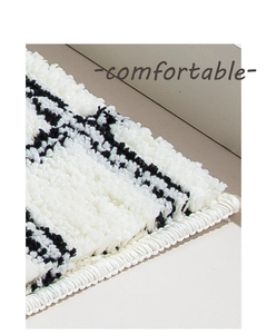 Macro detail of high-density bathroom mat with plush tufted texture and reinforced edges