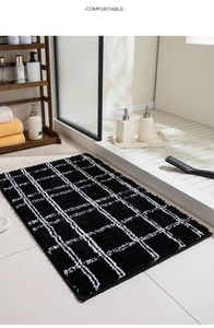 Close-up of black and white checkered bathroom mat with soft absorbent flocking texture