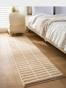 Close-up of soft flocked striped bedside rug texture on natural wood flooring