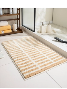 Detail of striped flocked bedside rug featuring soft textured pile and premium edge binding