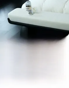 Close-up of minimalist black and white pixelated grid pattern rug on dark wood floor