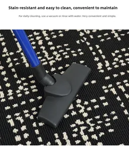 Macro view of easy-clean entryway mat showing vacuum cleaning on black woven fiber texture