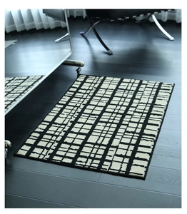 Detail of modern black and white grid pattern rug with premium woven texture on tile floor