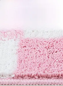 Close-up of pink and white checkered plush rug showing dense pile and high density texture