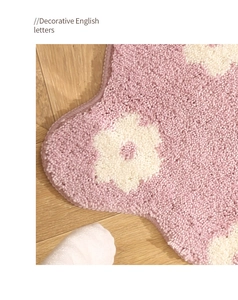 Close-up of pink flower bathroom mat showing soft plush texture and detailed fiber edges