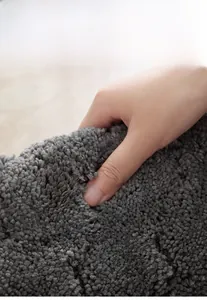 Macro shot of dark grey thick bathroom rug fibers showing durable non-shedding texture