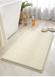 Dettaglio del tappetino da bagno bianco panna in memory foam con motivo a rilievo