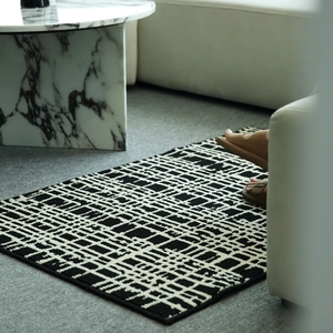 Modern black and white geometric grid entryway mat with minimalist French luxury design