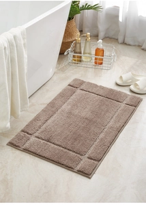 Thick absorbent bathroom mat in brown with a minimal frame design on marble floor