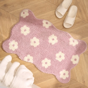 Pink floral absorbent plush bathroom mat with flower pattern on wooden floor