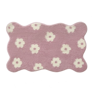 Pink floral bathroom rug with wavy edges and absorbent plush texture for bath mat decor