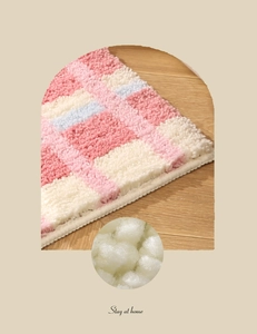Détail macro du tapis de bain à carreaux montrant les fibres et les bords finis