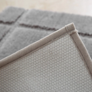 Absorbent dark gray bathroom mat with non-slip TPR backing and plush texture