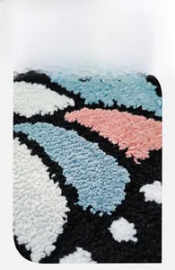 Close-up of thick plush bedroom carpet showing soft black and white butterfly pile texture