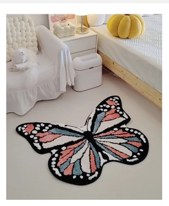 Detail of a butterfly-shaped tufted rug with soft plush texture in cream-style home decor
