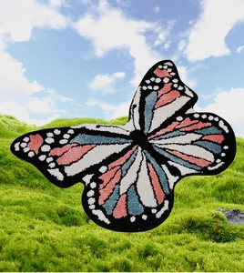 Macro detail of high-pile tufted butterfly rug with colorful fiber texture