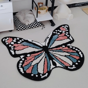 Thick tufted butterfly area rug with pink and blue wings on light wooden floor