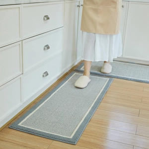 Gray woven anti-slip kitchen floor mat set with elegant white border on light wood floor