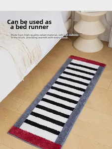 Close-up of fluffy black and white striped bedside rug with red and grey color accents