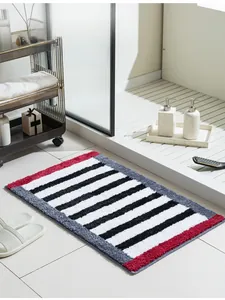Macro detail of thick plush non-slip bathroom mat with red and grey stripes