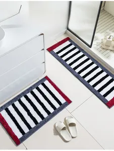 Detail of plush microfiber bathroom rug set with red grey borders and striped pattern