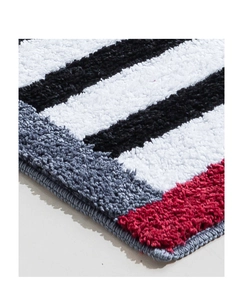 Macro detail of plush striped bedroom rug featuring soft microfiber and high pile texture