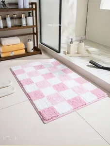 Detail of pink and white checkered bathroom rug with soft long plush texture