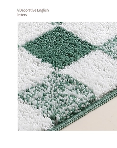 Close-up of green and white checkered bath mat with thick plush texture and hemmed edges