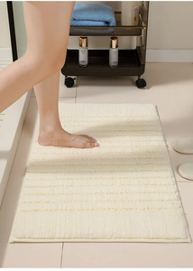Close-up of fluffy cream bathroom mat showing absorbent thick long-fiber texture