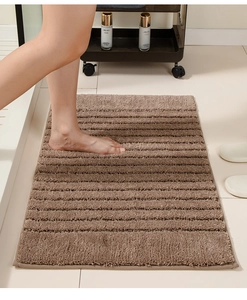 Detailed view of thick non-slip bathroom mat with soft brown stripes and plush texture