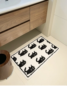 Detail view of thickened flocked bathroom mat featuring a cute black cartoon cat pattern