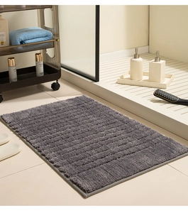 Detailed view of dark grey absorbent bathroom mat with thick striped microfiber texture