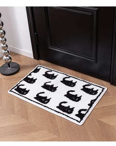 Close-up of fluffy cat silhouette rug texture and neat black overlock stitching edges