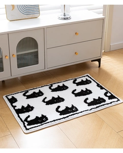 Close-up of black cat silhouette pattern on thick flocked bathroom mat with soft texture
