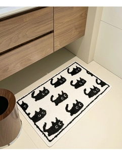 Detail of soft flocked cat pattern bath mat on light tile floor in minimalist bathroom