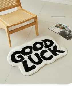 Cloud-shaped bathroom mat with Good Luck lettering on a soft white tufted surface