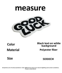 Detail view of white absorbent bath mat featuring Good Luck text and soft suede texture