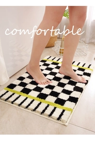 Close-up of thick plush checkerboard bath mat with vibrant stripe and soft texture