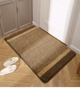 Macro detail of brown entrance mat with fiber texture on light wood flooring