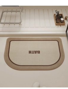 Detailed close-up of semi-circle linen bathroom mat with BATH lettering and non-slip texture