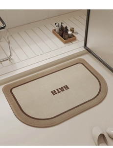 Detail of semi-circular linen woven bath mat with BATH lettering in a modern bathroom