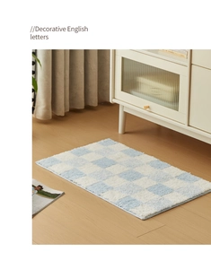 Detail of blue checkerboard bathroom mat with soft plush texture on wooden floor