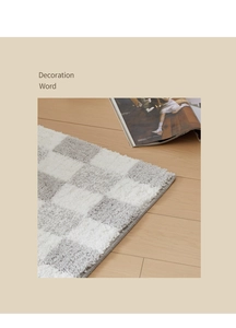 Detail of tufted checkered bathroom mat with soft texture and neat hemmed edges