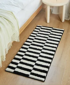 Detail of soft thick plush runner rug with classic black and white stripes for bedroom decor