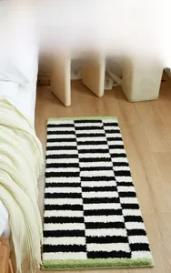 Close-up of thick checkered bedroom runner rug with soft flocking texture on wood floor