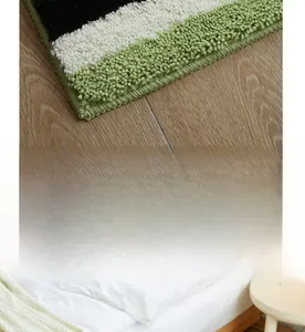 Close-up of striped flocking rug with avocado green accents and reinforced edges