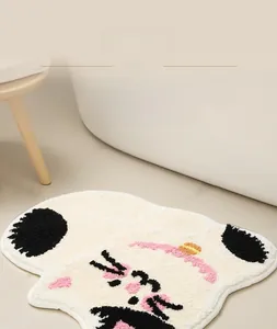 Close-up of cute cat-shaped plush bath mat featuring thick absorbent tufted fabric texture