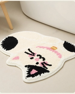 Close-up of cute cat-shaped plush bathroom mat with fluffy tufted texture and soft pile