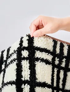 Close-up of thick, dense plush fibers on a checkered Bauhaus bathroom mat